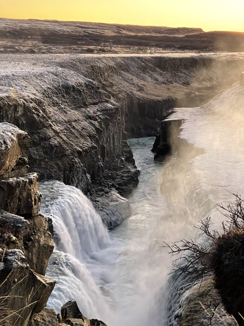 Waterfall in a frosted canyon at golden hour